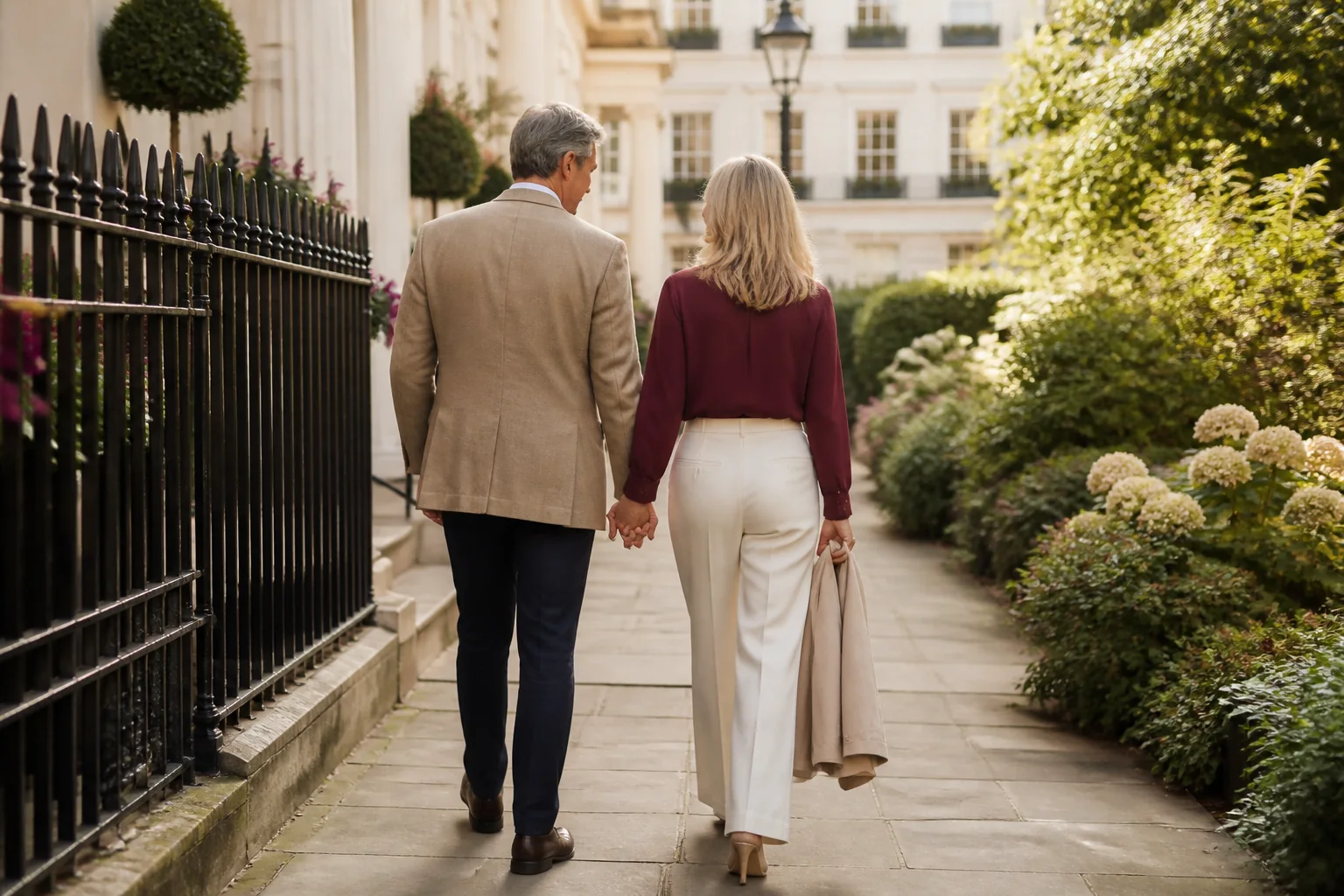Editorial photograph of an adult couple walking together through a London garden square